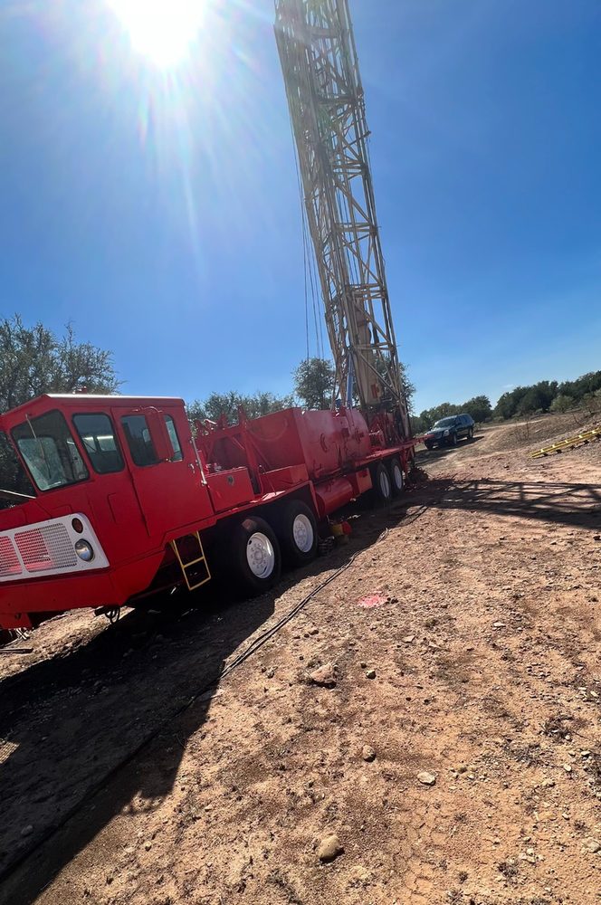 Workover rig parked beside a lease road